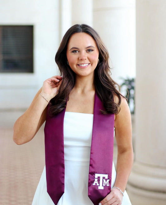 desden ambassador on graduation day wearing maroon stole for texas atm
