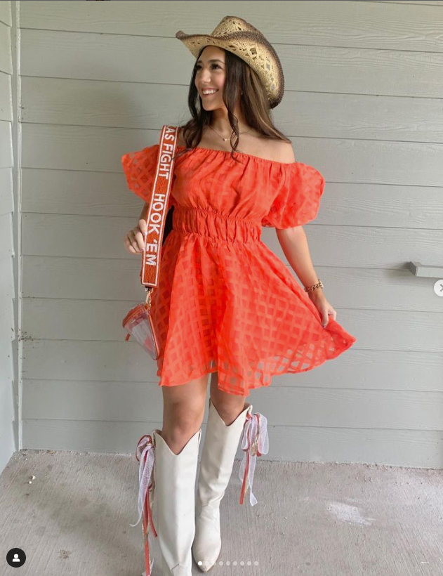 Texas Longhorn Fan in orange dress wearing beaded purse strap with clear purse from Desden 