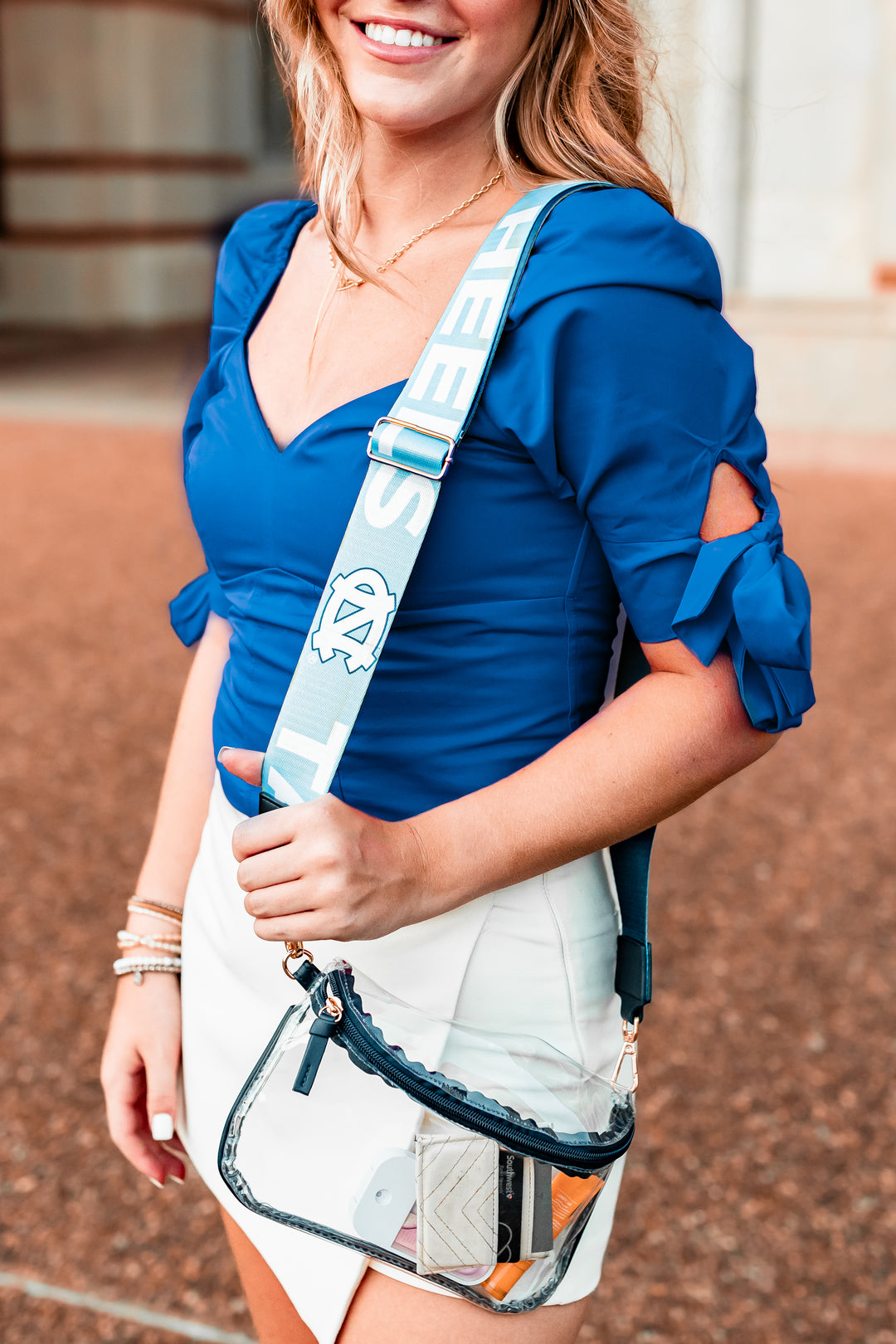 college fan wearing new hailey sling purse with wide purse strap