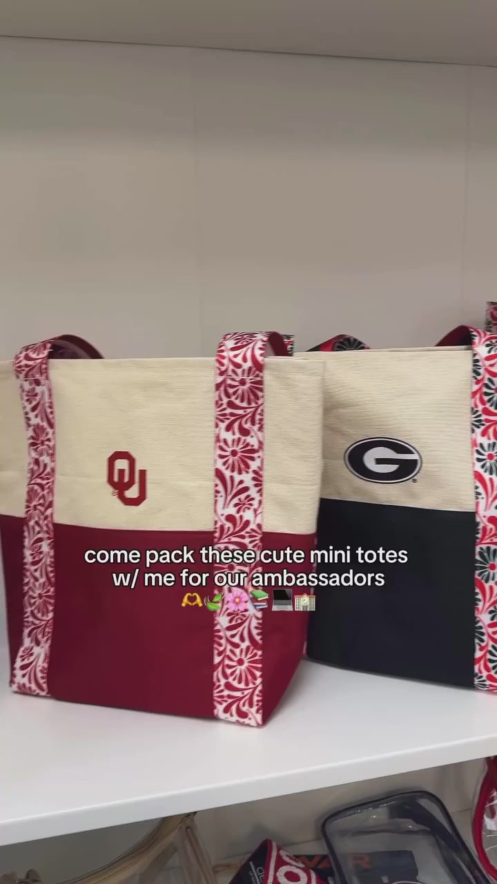 Starting the spring semester with fresh, upgraded, colorful mini totes 🌸 It’s the same mini size you love, but we upgraded the straps with a floral print to bring that vibrant energy into the year. So come pack these mini tote bag with me for our college ambassadors. Coming soon to the shop. [mini tote bag, college football team, officially licensed gameday accessories