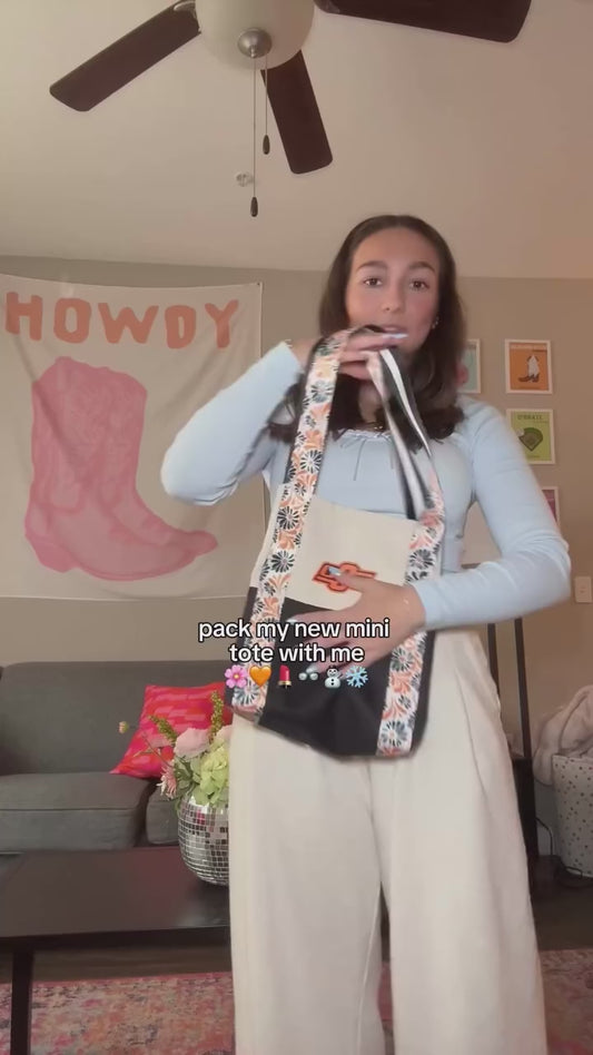 I’ve designed a lot of bags over the years, but this little one has always had my heart 😍 We brought in floral straps that feel soft and feminine without trying too hard, paired with a classic canvas tote body that keeps it grounded and easy. It’s the kind of balance I always look for. Something pretty, but still practical enough for everyday life. Each mini canvas tote bag is made here in the U.S., thoughtfully finished, and sized for the things you actually reach for. Lightweight, durable, and easy to st